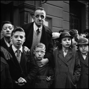 School Outing, Liverpool, 1952
This group of school children and their teacher were waiting to board a bus. Liverpudlians have always expressed an intensity rarely seen on other faces. When Evelyn Waugh described people like this in his novels, he was accused of fantasy.
