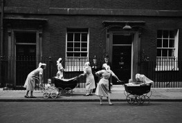 GB. England. Nannies Outside No.10. Downing Street was open to the public in those days and each afternoon the same nannies would pause to chat up the policemen on duty. 1959.