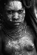 PAPUA NEW GUINEA. This girl was covered in white clay as part of the traditional mourning ceremony for her dead grandfather. In parts of New Guinea, people wear no clothes (in the western sense). For special occasions they paint bodies with pigments and adorn themselves with feathers and shells. 1973