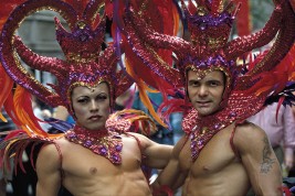 New York City. Gay Pride Parade. Two men sport elaborate headdresses.