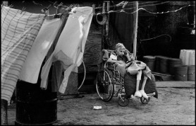 USA. Texas. Juana Rodriguez, 89, is cared for by her granddaughter-in-law, Juana Snell. "I want to cry when I don't have the water to wash her several times a day, she's like a baby" says Snell. 1987.
